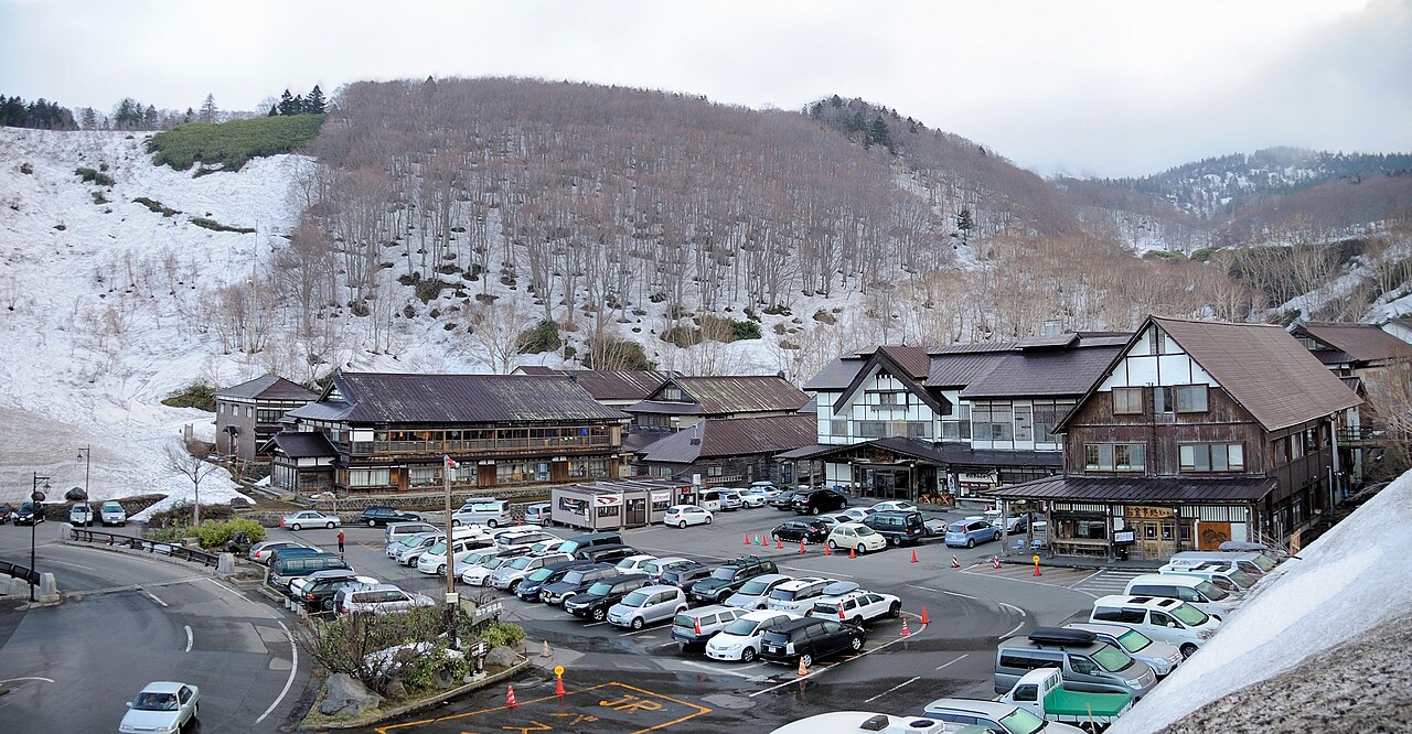 残雪期の酸ヶ湯温泉の全景と駐車場