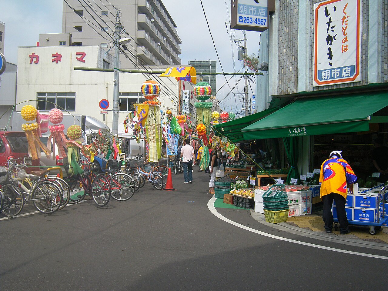 七夕飾りが吊るされた仙台朝市の店先と自転車が並ぶ通り